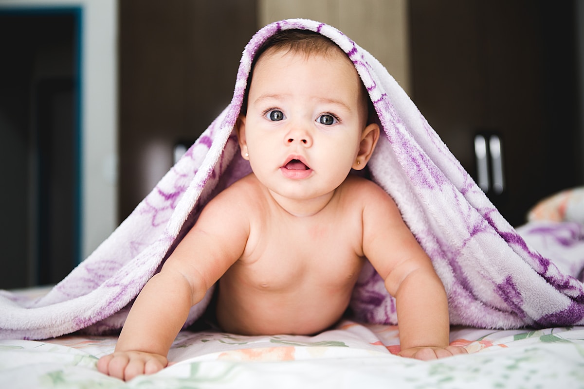 Newborn resting in a soft blanket