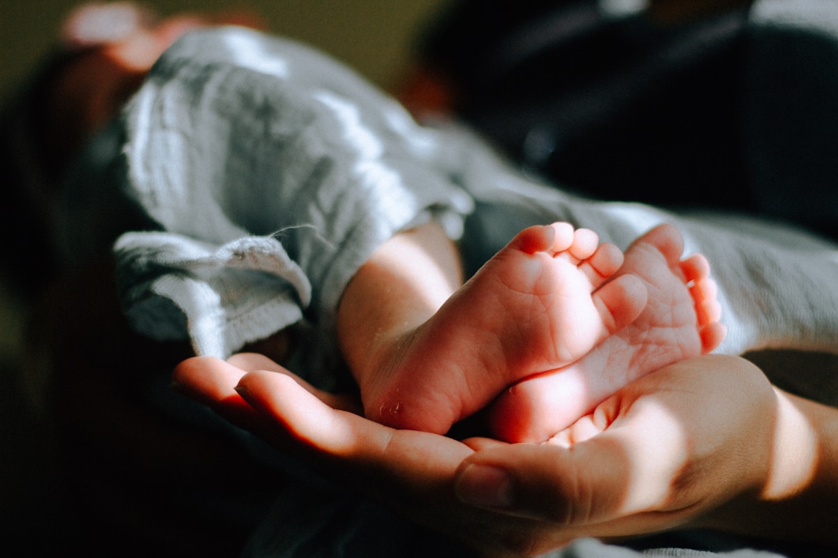 Parent holding newborn feet